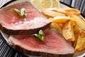 Beef steak is served with roasted potatoes and lemon close-up on Royalty Free Stock Photo