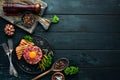 Beef steak tartare with raw egg yolk, pickled cucumber and onions. French cuisine. Royalty Free Stock Photo