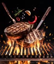 Beef steaks with spices fly over the blazing grill barbecue fire Royalty Free Stock Photo