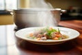 beef stew being ladled onto a plate, steam visibly rising Royalty Free Stock Photo