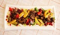 Beef stew with fresh vegetables, berries and lettuce on a large white plate Royalty Free Stock Photo