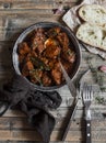 Beef stew in a frying pan on a wooden rustic table. Royalty Free Stock Photo