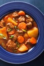 Beef stew with potato and carrot in blue plate Royalty Free Stock Photo