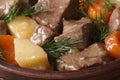 Beef stew with vegetables and dill in a pot macro. Royalty Free Stock Photo