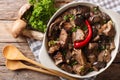 Beef stew with wild mushrooms, onion and chili pepper close up i Royalty Free Stock Photo