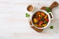 Beef stewed with vegetables on a white wooden background Royalty Free Stock Photo