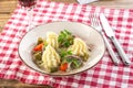 Beef stroganoff with mashed potatoes and pickles with glass of red wine on wooden table