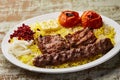 Beef Sultani with andana kabab, beef tikka and mandi biryani rice, tomato and onion served in dish isolated on table top view of