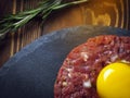 Beef tartar with an egg on a stone plate. Royalty Free Stock Photo