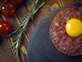 Beef tartar with an egg on a stone plate. Royalty Free Stock Photo