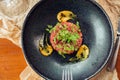 Above view of salmon tartar on a dark wooden background, studio shot Royalty Free Stock Photo