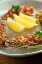 Beef tartar with salad and garlic toast on dark bread Royalty Free Stock Photo