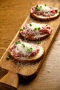 Beef tartar with salad and garlic toast on dark bread Royalty Free Stock Photo