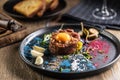 Beef tartare with egg yolk on a plate with garlic and toasted bread Royalty Free Stock Photo