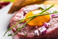 Beef tartare with egg yolk red onion chili peppers herbs and bruschetta Royalty Free Stock Photo