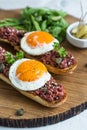 Beef tartare with pickled fried egg on top.