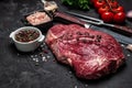 Beef tenderloin fillet with rosemary and spices on a dark background. Preparing fresh beef steak ready to cook, top view Royalty Free Stock Photo