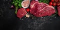 Beef tenderloin fillet with rosemary and spices on a dark background. Preparing fresh beef steak ready to cook, top view Royalty Free Stock Photo