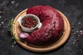 Beef tenderloin fillet with rosemary and spices on a dark background. Preparing fresh beef steak ready to cook, top view Royalty Free Stock Photo