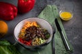 Beef Tenderloin Salad with pepper, orange, sesame seeds and herbs. Spoon and fork on a green tablecloth and gray background Royalty Free Stock Photo