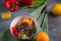 Beef Tenderloin Salad with pepper, orange, sesame seeds and herbs. Spoon and fork on a green tablecloth and gray background Royalty Free Stock Photo