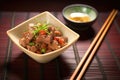 beef teriyaki with chopsticks and sake cup on bamboo mat Royalty Free Stock Photo