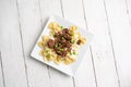 Beef tips over bow tie pasta and Alfredo sauce Royalty Free Stock Photo