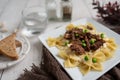 Beef tips over bow tie pasta and Alfredo sauce Royalty Free Stock Photo