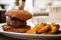 Beefburger with fried potatoes Royalty Free Stock Photo