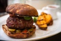 Beefburger with fried potatoes Royalty Free Stock Photo