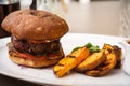 Beefburger with fried potatoes Royalty Free Stock Photo