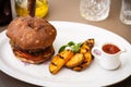 Beefburger with fried potatoes Royalty Free Stock Photo
