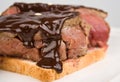 Beefsteak over toast poured chocolate