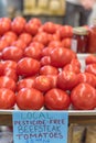 Beefsteak tomatoes on metal tray with price label at local market in Texas, America