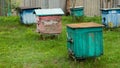 Old beehives with damaged paint in the yard of the village.