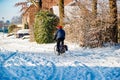 Beek, South Limburg, Netherlands. January 18, 2024. Man riding his bicycle and driving on street covered with snow