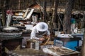 Beekeeper in overalls cleans the honeycomb, apiary