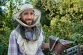 beekeeper in a protective mask smiling