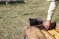 The beekeeper takes the honeycomb from the hive. Tool for smoking bees from the hive in the apiary. Harvesting honey, in the