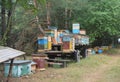 The beekeeper is transporting, relocating honey bees in numerous colorful wooden beehives by a tractor wagon to a new forest