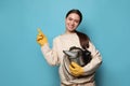Beekeeper in uniform with smokepot pointing at something on light blue background Royalty Free Stock Photo