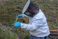 Beekeeper who is checking his honey production at Wolfenschissen on the Swiss alps