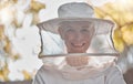 Beekeeper, woman and protective suit in portrait, happy and outddor with ppe, safety and agriculture. Senior bee farmer Royalty Free Stock Photo