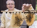 A Beekeeper working with bee quen cels Royalty Free Stock Photo