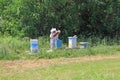 Beekeeper Working in her Bee Yard Checking Hives Royalty Free Stock Photo