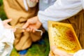 Beekeper gives the children the opportunity to taste honey.