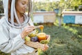 Beekeper with honey on the apiary Royalty Free Stock Photo