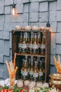 Beer and appetizing snacks. table with two mugs of lager, wooden board with grilled sausages, garlic and sauce, salted nuts.