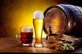 Beer barrel with beer glasses on a wooden table.