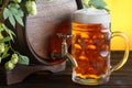 Beer barrel with fresh hops on it and beer glass Royalty Free Stock Photo